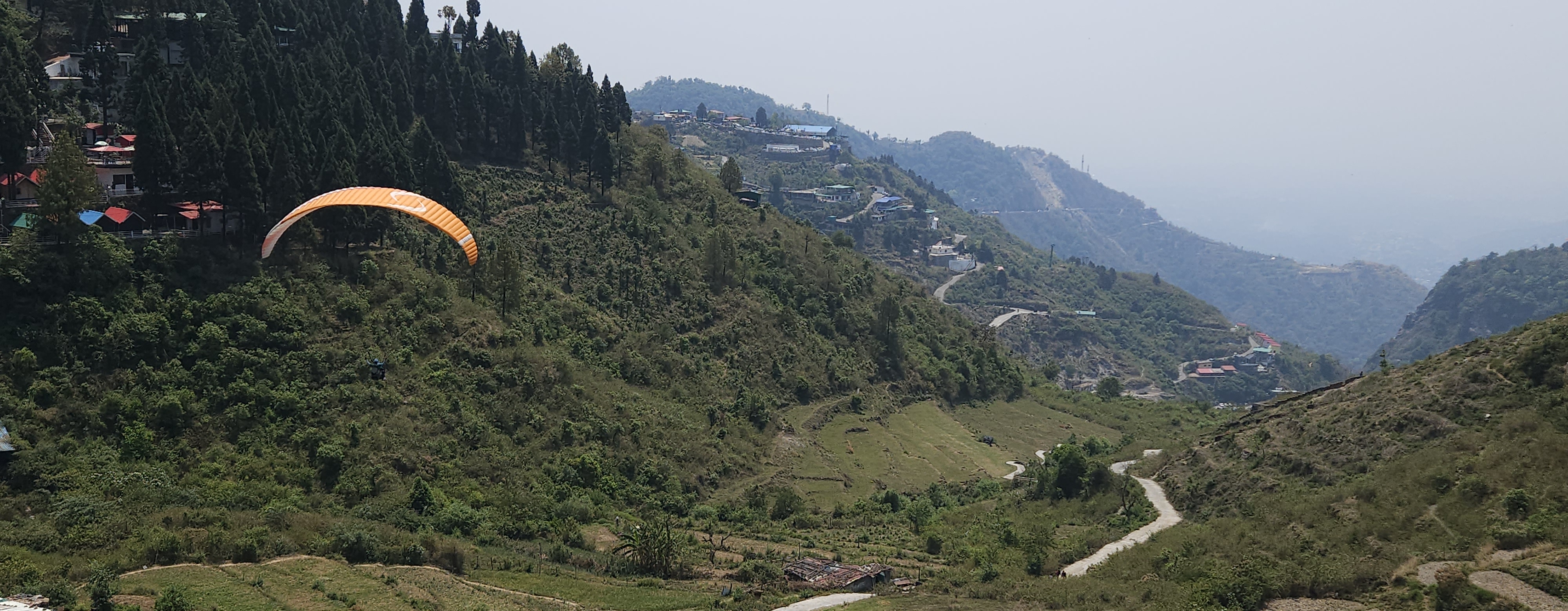 Thrilling paragliding experience with stunning aerial views of the mountains.